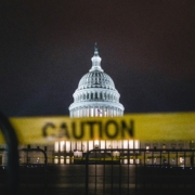 US capitol at night with caution tape