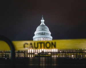 US capitol at night with caution tape