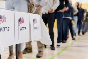 People waiting in line to vote at polls.