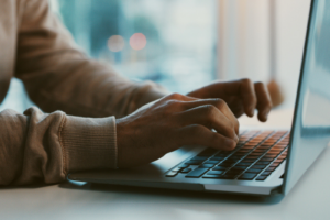 Shot of an unrecognizable businessman working on his laptop in the office