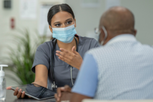 Female doctor talks with an older patient