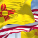 The New Mexico state flag waving along with the national flag of the United States of America