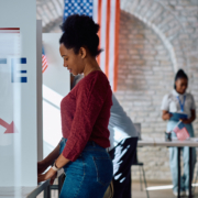 Black woman at voting booth during US elections.